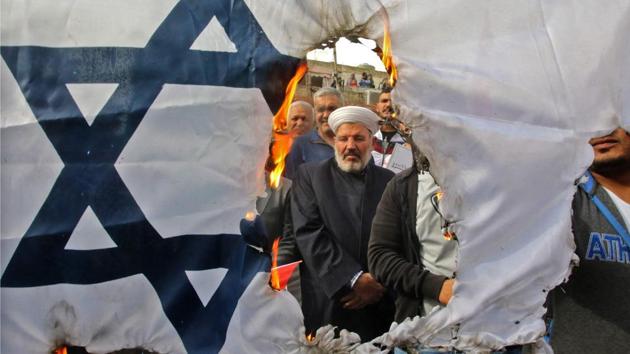 Protesters burn an Israeli flag during a demonstration, organized by Hezbollah, in the streets of the southern Lebanese port city of Sidon on December 22, 2017 to protest against US President Donald Trump's recognition of Jerusalem as Israel's capital. (Mahmoud Zayyat / AFP) Protesters burn an Israeli flag during a demonstration, organized by Hezbollah, in the streets of the southern Lebanese port city of Sidon on December 22, 2017 to protest against US President Donald Trump's recognition of Jerusalem as Israel's capital. (Mahmoud Zayyat / AFP)