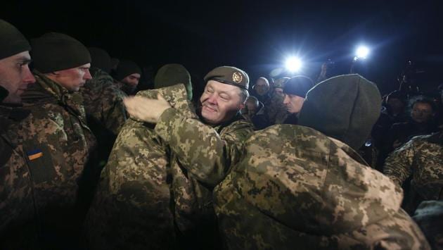 Ukrainian President Petro Poroshenko (C) welcomes servicemen who had been made prisoners, after their release during an exchange between Ukraine and pro-Russia rebels near the city of Bakhmut, Donetsk region. Ukraine and Russian-backed rebels swapped hundreds of prisoners in the war-torn east of the country on December 27. (Mikhail Palinchak / Ukranian Presidential Press Service / AFP) Ukrainian President Petro Poroshenko (C) welcomes servicemen who had been made prisoners, after their release during an exchange between Ukraine and pro-Russia rebels near the city of Bakhmut, Donetsk region. Ukraine and Russian-backed rebels swapped hundreds of prisoners in the war-torn east of the country on December 27. (Mikhail Palinchak / Ukranian Presidential Press Service / AFP)