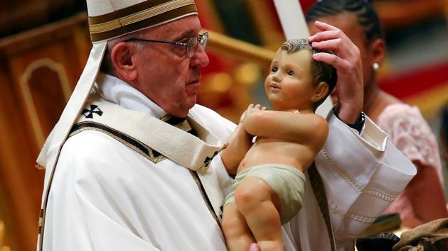Pope Francis holds a statuette of baby Jesus during the traditional midnight mass in St. Peter's Basilica on Christmas Eve at the Vatican on December 24, 2017. (Tony Gentile / REUTERS) Pope Francis holds a statuette of baby Jesus during the traditional midnight mass in St. Peter's Basilica on Christmas Eve at the Vatican on December 24, 2017. (Tony Gentile / REUTERS)