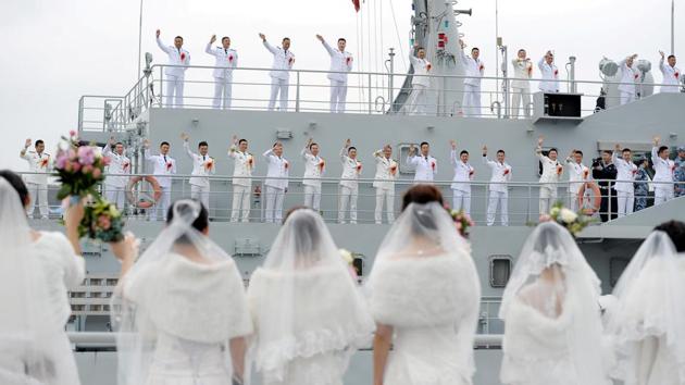 Navy personnel of the Chinese People's Liberation Army (PLA) wave at their brides during a mass wedding at a military base in Zhoushan, Zhejiang province, China on December 29, 2017. (REUTERS) Navy personnel of the Chinese People's Liberation Army (PLA) wave at their brides during a mass wedding at a military base in Zhoushan, Zhejiang province, China on December 29, 2017. (REUTERS)