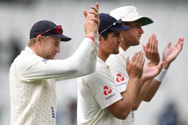 England's Joe Root (L), Alastair Cook (C) and Stuart Broad applaud the England fans. (AFP)