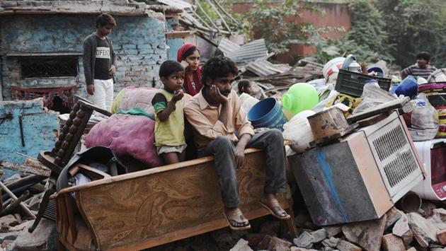 In Delhi’s Kathputli colony, an artist sits on his belongings outside his home, as the DDA went through with its demolition drive in the area.  (Sanchit Khanna / HT Photo) 