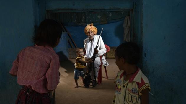 Former Chambal dacoit Munna Singh with his rifle in his home in Bhind district. Now 70, the former dacoit surrendered in 1982 and now teaches children at the village school. (Raj K Raj / HT Photo) 