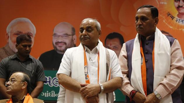 Deputy chief minister Nitin Patel (left) has been sulking after the key finance, urban development and petrochemicals portfolios were snatched away from him to accommodate Saurabh Patel, who was dropped in the previous Vijay Rupani government. (AP File Photo) Deputy chief minister Nitin Patel (left) has been sulking after the key finance, urban development and petrochemicals portfolios were snatched away from him to accommodate Saurabh Patel, who was dropped in the previous Vijay Rupani government. (AP File Photo)