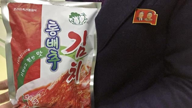 In this December 20, 2017, photo, manager Paek Mi Hye holds a package of kimchi produced at the Ryugyong Kimchi Factory on the outskirts of Pyongyang, North Korea. (AP) In this December 20, 2017, photo, manager Paek Mi Hye holds a package of kimchi produced at the Ryugyong Kimchi Factory on the outskirts of Pyongyang, North Korea. (AP)