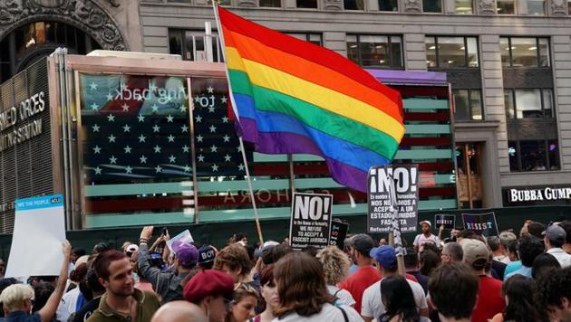 A rainbow flag flies as people protest US President Donald Trump's announcement that he plans to reinstate a ban on transgender individuals from serving in any capacity in the US military, in Times Square, in New York City on July 26, 2017. (REUTERS FILE) A rainbow flag flies as people protest US President Donald Trump's announcement that he plans to reinstate a ban on transgender individuals from serving in any capacity in the US military, in Times Square, in New York City on July 26, 2017. (REUTERS FILE)