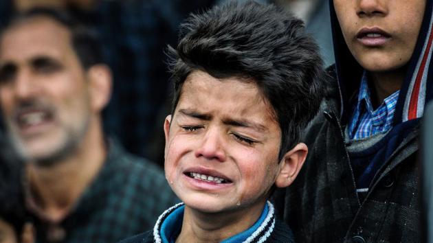 Nine-year-old Burhan Fayaz breaks into tears at the funeral of his friend Amir Nazir, a civilian who was killed during an encounter in Pulwama in March after being hit by a bullet in the neck. Thousands, including Burhan, attended the funeral in Begumbagh village, some four kilometres from the site of the gun battle where he was felled. (Waseem Andrabi / HT Photo) 