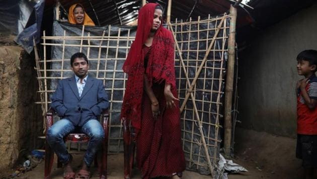Saddam Hussein, and his newly-wed wife Shofika Begum pose for a photo in front of their temporary shelter after their marriage is solemnised. (Marko Djurica / REUTERS) Saddam Hussein, and his newly-wed wife Shofika Begum pose for a photo in front of their temporary shelter after their marriage is solemnised. (Marko Djurica / REUTERS)