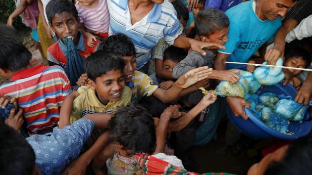 The free meal is distributed to children in plastic bags, but a scuffle that erupts at the camp overflowing with residents vying for scant resources means that some of it ends up in the mud. (Damir Sagolj / REUTERS) The free meal is distributed to children in plastic bags, but a scuffle that erupts at the camp overflowing with residents vying for scant resources means that some of it ends up in the mud. (Damir Sagolj / REUTERS)