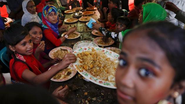 Religious rites out of the way, the party begins shortly after, with a large meal served in a big tent to 20 guests at a time. A cow was slaughtered the day before and a curry prepared for the feast. Men are served first, then the women sit down and lastly, the children eat. (Damir Sagolj / REUTERS) Religious rites out of the way, the party begins shortly after, with a large meal served in a big tent to 20 guests at a time. A cow was slaughtered the day before and a curry prepared for the feast. Men are served first, then the women sit down and lastly, the children eat. (Damir Sagolj / REUTERS)