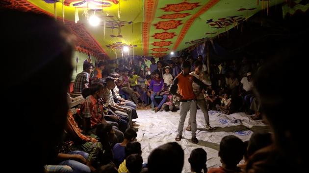 After everyone has had their fill, the long tables and plastic chairs are removed, and a loudspeaker is hooked up. It’s time now for a dance. A professional dancer and his two assistants take to the floor with flashy moves to warm up the crowd. Soon, everyone is clapping and on their feet. (Damir Sagolj / REUTERS) After everyone has had their fill, the long tables and plastic chairs are removed, and a loudspeaker is hooked up. It’s time now for a dance. A professional dancer and his two assistants take to the floor with flashy moves to warm up the crowd. Soon, everyone is clapping and on their feet. (Damir Sagolj / REUTERS)