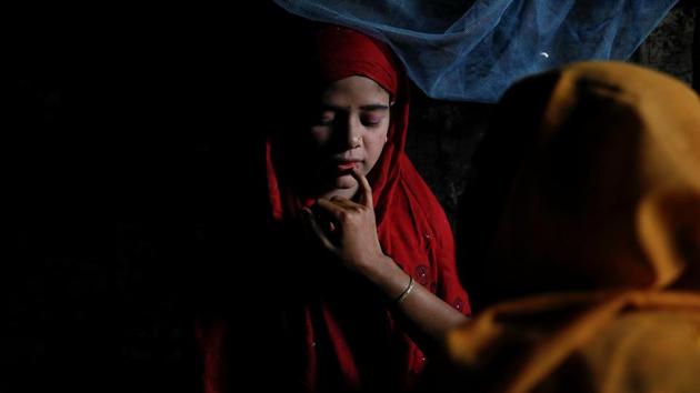Shofika Begum is helped with bridal make-up by her brother’s wife on the day of her wedding. She spent much of the day cloistered in a separate tent, attended to by female relatives. (Damir Sagolj / REUTERS) Shofika Begum is helped with bridal make-up by her brother’s wife on the day of her wedding. She spent much of the day cloistered in a separate tent, attended to by female relatives. (Damir Sagolj / REUTERS)