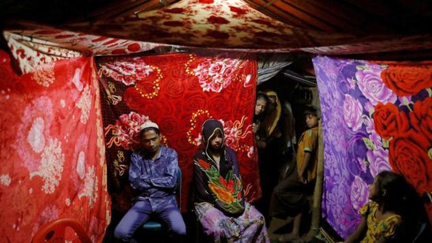 Decorative patterns inked in henna line Shofika Begum’s hands, her groom Saddam Hussein is perfumed and guests feast and dance the night away in a colourful tent. In most ways, the day mirrors that of couples getting married the world over. The difference is the venue --Kutupalong refugee camp in Bangladesh’s Cox’s Bazar, where about 660,000 stateless Rohingya from Myanmar have sought refuge since late August. (Damir Sagolj / REUTERS) Decorative patterns inked in henna line Shofika Begum’s hands, her groom Saddam Hussein is perfumed and guests feast and dance the night away in a colourful tent. In most ways, the day mirrors that of couples getting married the world over. The difference is the venue --Kutupalong refugee camp in Bangladesh’s Cox’s Bazar, where about 660,000 stateless Rohingya from Myanmar have sought refuge since late August. (Damir Sagolj / REUTERS)