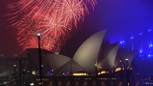 The "family fireworks", displayed three hours before midnight every year ahead of the main show, fill the sky over the Opera House in Sydney on New Year's Eve. (Saeed Khan / AFP) The "family fireworks", displayed three hours before midnight every year ahead of the main show, fill the sky over the Opera House in Sydney on New Year's Eve. (Saeed Khan / AFP)