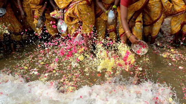 Women offer flowers into the sea during a ceremony for the victims of the 2004 tsunami at Pattinapakkam Beach in Chennai on December 26, 2017. The earthquake and tsunami that struck the Indian Ocean on December 26, 2004 killed over 230,000 people and devastated coastal communities, including the shorelines Tamil Nadu, Andhra Pradesh, and Kerala. (AFP)