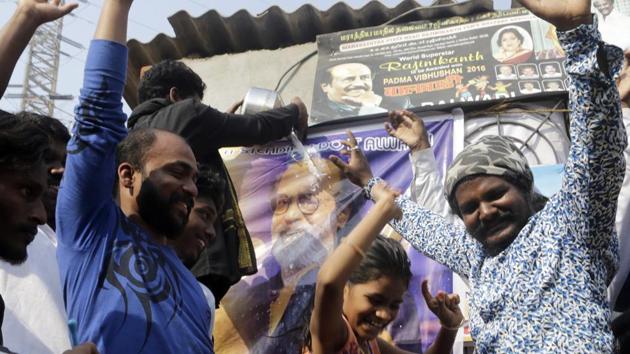 People celebrate and pour milk on an image of movie superstar Rajinikanth after he announced his plans to form a political party in Mumbai, on Sunday. (AP) People celebrate and pour milk on an image of movie superstar Rajinikanth after he announced his plans to form a political party in Mumbai, on Sunday. (AP)