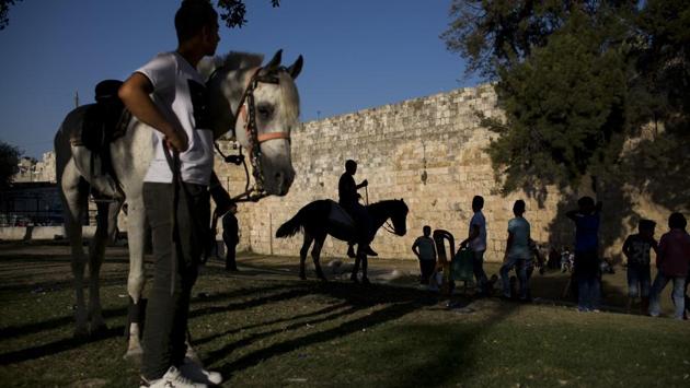 Palestinians ride horses during the Eid al-Fitr holiday outside Damascus Gate in Jerusalem. These conflicting claims have erupted into violence numerous times in the past. On December 6, 2017 President Donald Trump’s recognition of Jerusalem as Israel’s capital enraged Palestinians and much of the Muslim world. (Oded Balilty / AP) Palestinians ride horses during the Eid al-Fitr holiday outside Damascus Gate in Jerusalem. These conflicting claims have erupted into violence numerous times in the past. On December 6, 2017 President Donald Trump’s recognition of Jerusalem as Israel’s capital enraged Palestinians and much of the Muslim world. (Oded Balilty / AP)