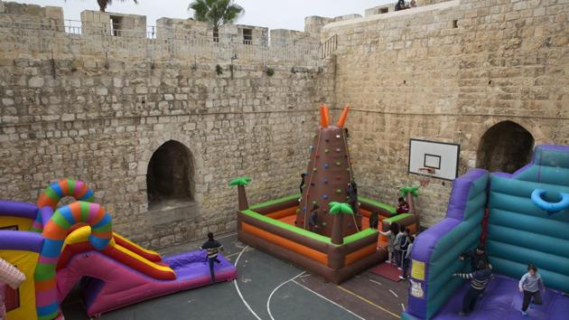 Israeli Arab Christian school kids play in De La Salle School’s basketball yard surrounded by the Old City walls next to the New Gate. Amid prolonged political conflicts spanning decades, day-to-day life continues to flourish within these historic sand-hued stone walls. (Oded Balilty / AP) Israeli Arab Christian school kids play in De La Salle School’s basketball yard surrounded by the Old City walls next to the New Gate. Amid prolonged political conflicts spanning decades, day-to-day life continues to flourish within these historic sand-hued stone walls. (Oded Balilty / AP)