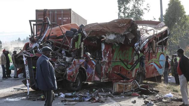 People look at the wreckage of a bus and a lorry that crashed in a head-on collision at the accident scene near Nakuru, Kenya, on December 31, 2017. (AFP Photo) People look at the wreckage of a bus and a lorry that crashed in a head-on collision at the accident scene near Nakuru, Kenya, on December 31, 2017. (AFP Photo)