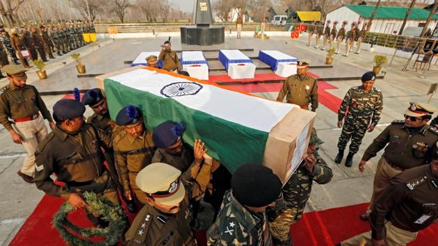 Central Reserve Police Force personnel carry a coffin containing a body of their colleague, who was killed during a gun battle with suspected militants at CRPF training centre, in Lethpora in south Kashmir’s Pulwama district, on Sunday. (REUTERS)