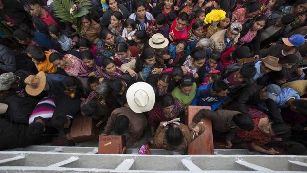 Villagers place the remains of their relatives in niche graves at a cemetery in Guatemala. There is no official figure of how many people died of hunger and untreated diseases in the model villages, but there were more than 45 such villages, according to a report titled Recovery of Historic Memory prepared by the Roman Catholic Church, and Santa Avelina was just one of them. (Luis Soto / AP)