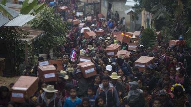 Ixil Mayans carry the remains of their loved ones for burial in Guatemala. It wasn’t only bullets and violence that killed thousands of indigenous people during 1960-1996 civil wars. The governments forced tens of thousands of farmers into model villages under strict army control to isolate them from guerrillas but instead were left to die of malnutrition and treatable illnesses. Now, in the hamlet of Santa Avelina, their bodies are being unearthed, identified and reburied. (Luis Soto / AP)