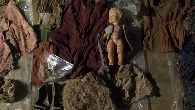 Clothing, earrings and a doll that were found among the remains of over 100 Ixil Mayans exhumed from a mass grave. The Catholic report explains that besides a lack of medical care, hunger may have played a role in what happened in Santa Avelina and other model villages. “The basic diet consisted of three tortillas and some beans for all three daily meals, on occasion a bit of rice,” the report read. (Luis Soto / AP)