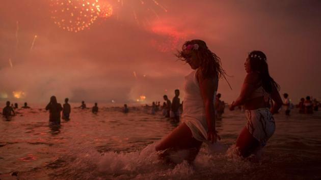People watch fireworks during New Years celebrations at Copacabana beach in Rio de Janeiro. (Mauro Pimentel / AFP) People watch fireworks during New Years celebrations at Copacabana beach in Rio de Janeiro. (Mauro Pimentel / AFP)