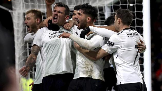 Liverpool's Ragnar Klavan celebrates scoring his side's first goal of the game against Burnley with teammates during the Premier League at Turf Moor on Monday. (AP) Liverpool's Ragnar Klavan celebrates scoring his side's first goal of the game against Burnley with teammates during the Premier League at Turf Moor on Monday. (AP)