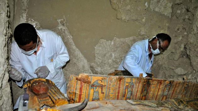 Members of an Egyptian archaeological team work on a wooden coffin discovered in a 3,500-year-old tomb in the Draa Abul Nagaa necropolis, near the southern Egyptian city of Luxor, on April 18, 2017.(AFP Photo/Representative image)