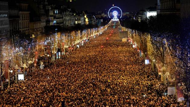 New Year revellers gather on the Champs-Elysees avenue in Paris. (Guillaume Souvant / AFP) New Year revellers gather on the Champs-Elysees avenue in Paris. (Guillaume Souvant / AFP)