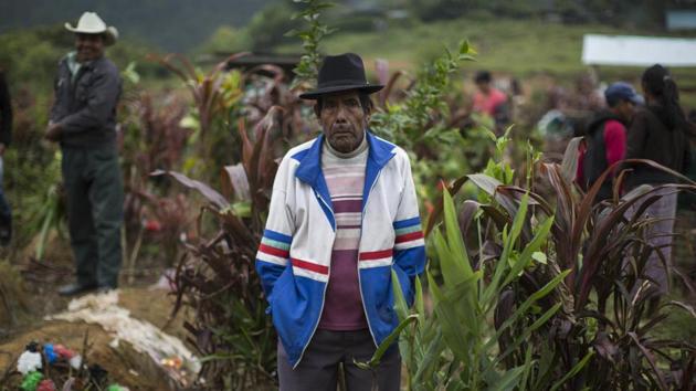 Tomas Cavinal Toma, 70, watches the burial of civil war victims at a cemetery. Edgar Perez, lawyer for the families who accuse Rios Montt of genocide, said the cases of the displaced have not been tried and that “these victims have been forgotten by justice.” Rios was convicted in 2013 and sentenced to 80 years in prison for genocide, but the Constitutional Court overruled the decision and ordered a new trial. (Luis Soto / AP)