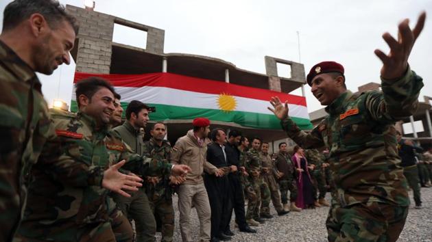 Iraqi Kurdish Peshmerga members dance during a gathering to celebrate the New Year on the frontline in Makhmur. (Safin Ahmed / AFP) Iraqi Kurdish Peshmerga members dance during a gathering to celebrate the New Year on the frontline in Makhmur. (Safin Ahmed / AFP)