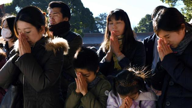Worshippers pray during a New Year's Day visit to Meiji shrine in Tokyo on January 1, 2018. Millions of Japanese people visit shrines and temples across the country during the first three days of the new year to pray for the well-being of their families. (Kazuhiro Nogi / AFP) Worshippers pray during a New Year's Day visit to Meiji shrine in Tokyo on January 1, 2018. Millions of Japanese people visit shrines and temples across the country during the first three days of the new year to pray for the well-being of their families. (Kazuhiro Nogi / AFP)
