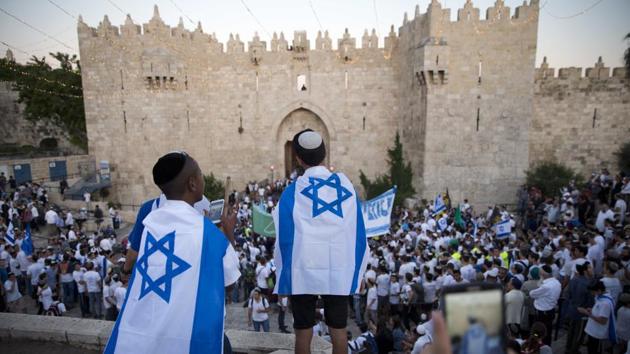Israelis carry national flags outside the Old City’s Damascus Gate in Jerusalem, during Jerusalem Day which marks the 50th anniversary of Israel’s capture of the city’s eastern half from Jordanian control during the Six-Day War in 1967. (Oded Balilty / AP) Israelis carry national flags outside the Old City’s Damascus Gate in Jerusalem, during Jerusalem Day which marks the 50th anniversary of Israel’s capture of the city’s eastern half from Jordanian control during the Six-Day War in 1967. (Oded Balilty / AP)