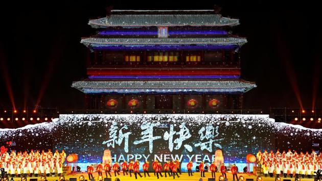 People dance to celebrate the new year during a countdown event at Yongdingmen Gate in Beijing, China. (Jason Lee / REUTERS) People dance to celebrate the new year during a countdown event at Yongdingmen Gate in Beijing, China. (Jason Lee / REUTERS)