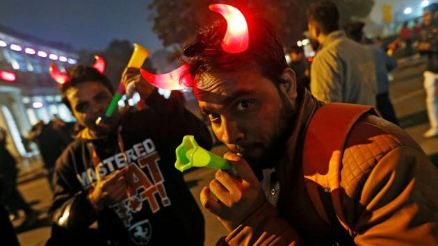 People dance during the New Year’s celebrations at a market area in New Delhi. (Reuters) People dance during the New Year’s celebrations at a market area in New Delhi. (Reuters)