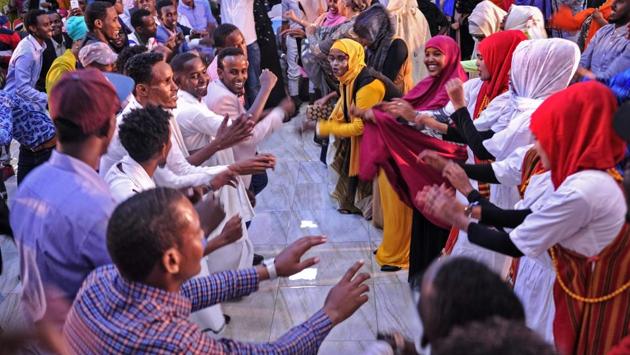 Somali women and men enjoy a traditional dance as they celebrate the coming 2018 on New Year's eve in Mogadishu, Somalia. (Mohamed Abdiwahab / AFP) Somali women and men enjoy a traditional dance as they celebrate the coming 2018 on New Year's eve in Mogadishu, Somalia. (Mohamed Abdiwahab / AFP)