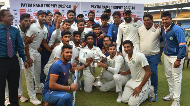 Vidarbha players celebrate with the trophy after winning the Ranji Trophy final against Delhi in Indore on Monday. (PTI) Vidarbha players celebrate with the trophy after winning the Ranji Trophy final against Delhi in Indore on Monday. (PTI)