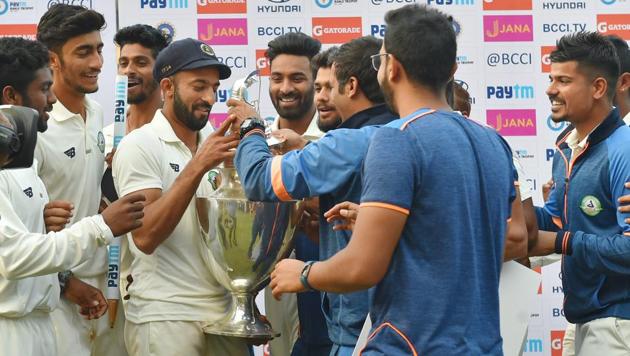 Vidarbha captain Faiz Fazal and his teammates celebrate with the Ranji Trophy after beating Delhi in Indore on Monday. (PTI) Vidarbha captain Faiz Fazal and his teammates celebrate with the Ranji Trophy after beating Delhi in Indore on Monday. (PTI)