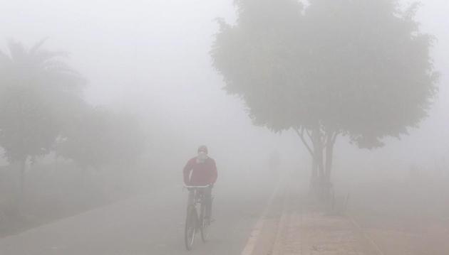 A man pedals his bicycle in dense morning fog in Amritsar on Tuesday. (PTI) A man pedals his bicycle in dense morning fog in Amritsar on Tuesday. (PTI)
