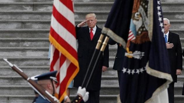US President Donald Trump salutes as he presides over a military parade.(REUTERS)
