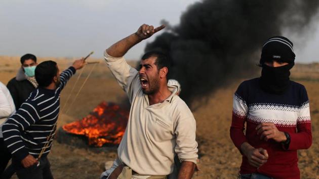 A Palestinian demonstrator reacts during clashes with Israeli troops at a protest against US President Donald Trump's decision to recognize Jerusalem as the capital of Israel, near the border with Israel in the southern Gaza Strip on December 29, 2017. (Reuters Photo)