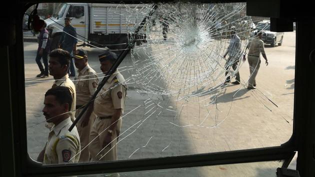 Indian policemen walk past the broken window of a bus after a Republican Party of India (RPI) protest turned violent in Mumbai. In Thane, hundreds of protesters sat on the roads, forced shops to down shutters and smashed seven state-owned buses. Reports of violence and stone pelting were also reported from Pune and Solapur with police blaming workers from the Republican Party of India (RPI). (AFP) Indian policemen walk past the broken window of a bus after a Republican Party of India (RPI) protest turned violent in Mumbai. In Thane, hundreds of protesters sat on the roads, forced shops to down shutters and smashed seven state-owned buses. Reports of violence and stone pelting were also reported from Pune and Solapur with police blaming workers from the Republican Party of India (RPI). (AFP)