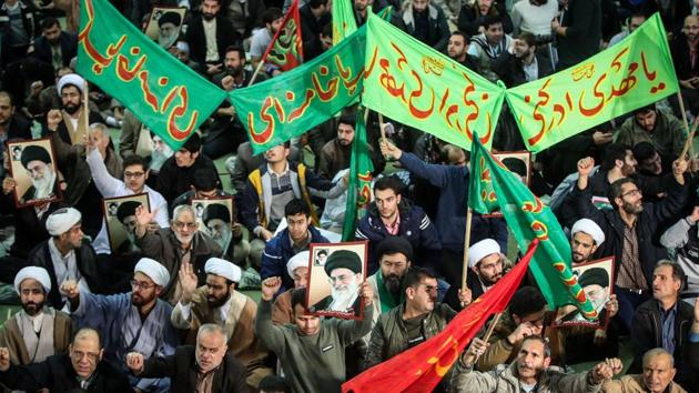 Pro-government groups seen here marching near the Imam Khomeini grand mosque in Tehran. Demonstrations in Iran continued for a fifth day on Monday after what began as protests over high living costs, and quickly spread across the country turning against the Islamic system as a whole, with chants of “Death to the dictator” and attacks on symbols of the regime. 13 people were reported killed so far. (Hamed Malekpour / Tasnim News / AFP) Pro-government groups seen here marching near the Imam Khomeini grand mosque in Tehran. Demonstrations in Iran continued for a fifth day on Monday after what began as protests over high living costs, and quickly spread across the country turning against the Islamic system as a whole, with chants of “Death to the dictator” and attacks on symbols of the regime. 13 people were reported killed so far. (Hamed Malekpour / Tasnim News / AFP)