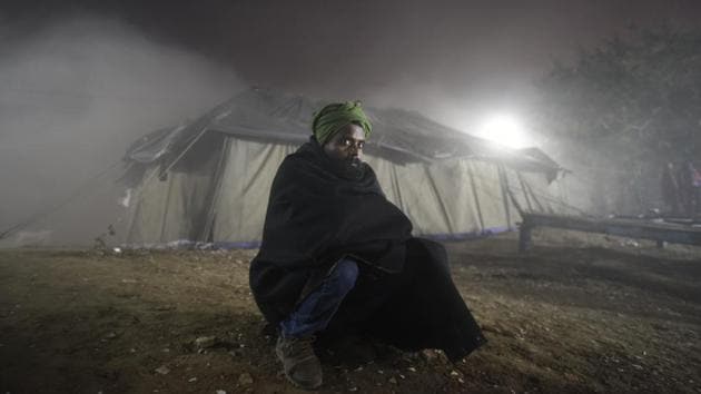 A homeless man watching Hindi film, Ek Tha Tiger, at a temporary open theatre in north Delhi on New Year’s Eve.(Burhaan Kinu/HT Photo)