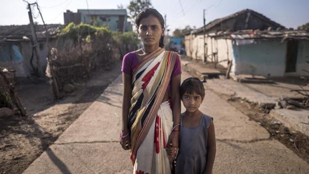 Mangala Pawar, 28, here with her daughter, lost her husband Gajanan to a tigress attack in August. The Hyderabad-based government-authorised shooter Nawab Shafath Ali Khan raises concern about the potential for further loss of life and man-animal conflict, the longer the tigress roams free.“Having such an animal on the prowl effectively turns about 25,000 villagers into enemies of all tigers in the area,” he says. (Pratik Chorge / HT Photo) 