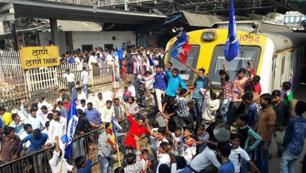 Protesters block trains at Thane railway station. Train services were badly affected in Mumbai after rail rokos on all three corridors of the Central Railway as well as on the Western Railway during a state-wide bandh called by Dalit groups on Wednesday. (Praful Gangurde / HT Photo)