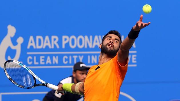 Yuki Bhambri serves to Pierre-Hugues Herbert during their second round at the Tata Open tennis tournament (Maharashtra) at the Shiv Chhatrapati Sports Complex in Pune on Wednesday.(HT Photo)