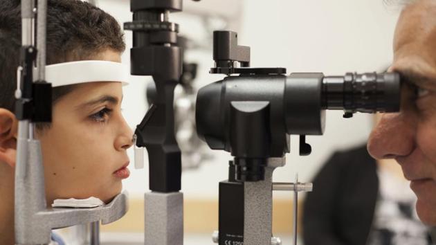 In this file photo, Dr. Albert Maguire, right, checks the eyes of Misa Kaabali, 8, at the Children's Hospital of Philadelphia. Misa was 4-years-old when he received his gene therapy treatment. The first-of-its kind genetic treatment for blindness will cost $850,000, less than the $1 million price tag that had been expected, but it's still among the most expensive genetic therapies in the world. (AP Photo) In this file photo, Dr. Albert Maguire, right, checks the eyes of Misa Kaabali, 8, at the Children's Hospital of Philadelphia. Misa was 4-years-old when he received his gene therapy treatment. The first-of-its kind genetic treatment for blindness will cost $850,000, less than the $1 million price tag that had been expected, but it's still among the most expensive genetic therapies in the world. (AP Photo)